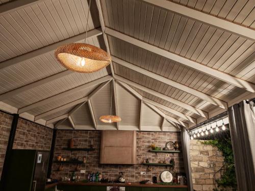 a kitchen with two lights hanging from the ceiling at Zeyvə Farm House 