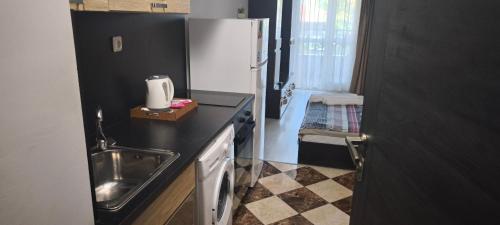 a small kitchen with a sink and a refrigerator at Studio 6-2 Hristo Stanechev 2- Dental University in Bŭnzareto