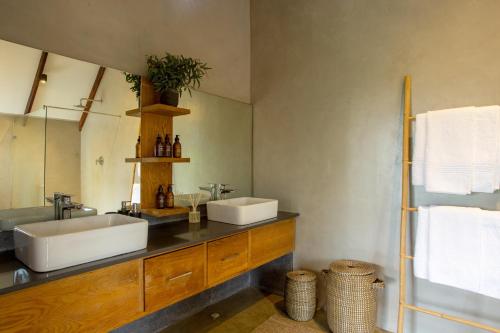 a bathroom with two sinks and a large mirror at House Nyala in Lydenburg