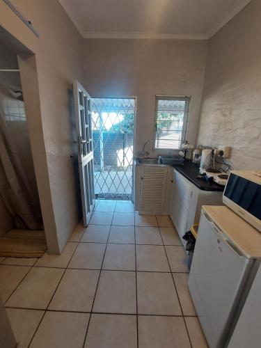 a kitchen with a sink and a counter top at Turtle Creek - Ridleys in Umkomaas