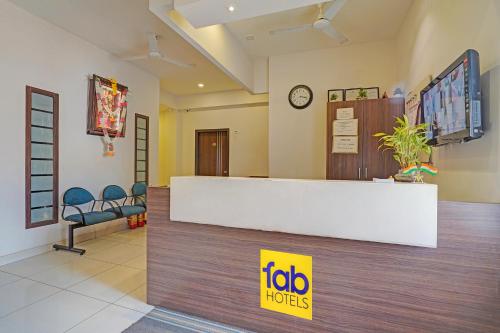 a hospital lobby with a reception desk and chairs at FabExpress Urban Inn - Yeswanthpur in Bengaluru