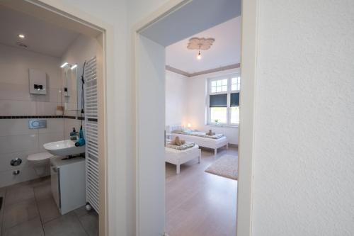 a bathroom with a sink and a toilet in a room at HagenStay Eilpe 1 in Hagen