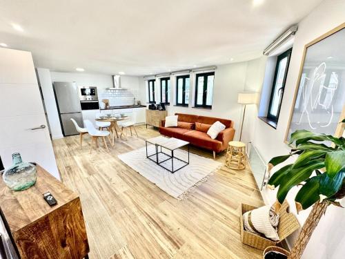 a living room with a couch and a table at Gestviva Casa Urbanin III in Cudillero