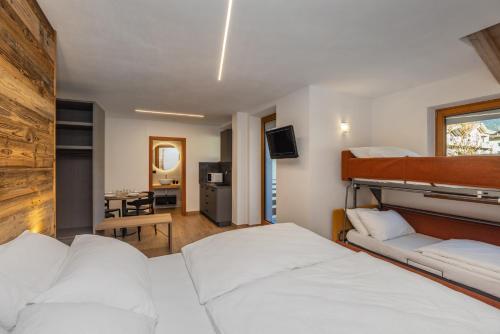 a hotel room with a bed and a television at B&B Soreghina in Malè