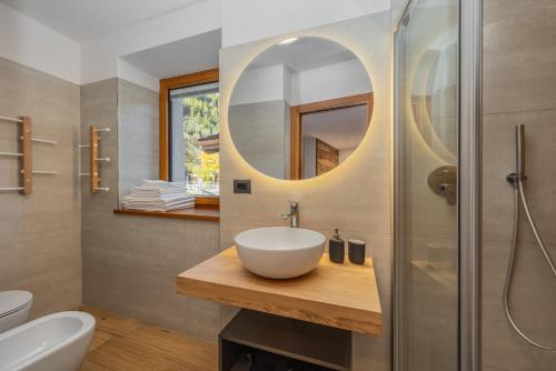 a bathroom with a sink and a shower at B&B Soreghina in Malè