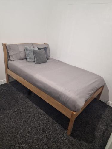 a bed with two pillows on it in a room at The Nightingale in Lower Darwen