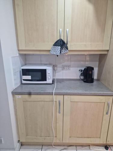 a microwave sitting on a counter in a kitchen at The Nightingale in Lower Darwen
