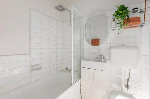 a white bathroom with a tub and a sink at Villa Amari - A Sunny Tranquil Home in Melbourne