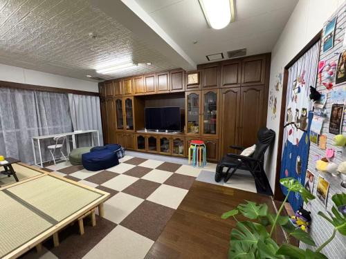 a living room with a checkered floor and a tv at Direct to Shinjuku 15 mins 3rooms Up to 9 Guests in Tokyo