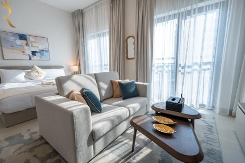 a living room with a couch and a bed at Stylish Yas Studio- Modern Urban Stay in Abu Dhabi