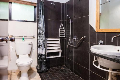 a bathroom with a toilet and a sink at Lodge Forest Suite in Hluhluwe