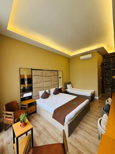 a hotel room with a large bed and a couch at Berfinn Hotel Ortaköy in Istanbul