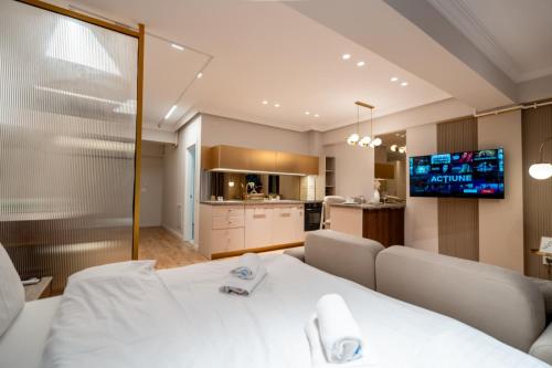 a living room with a white table and a kitchen at Elegant Ivory Studio by Blvd 16B7 - Quiet Garden View in Pipera in Pipera