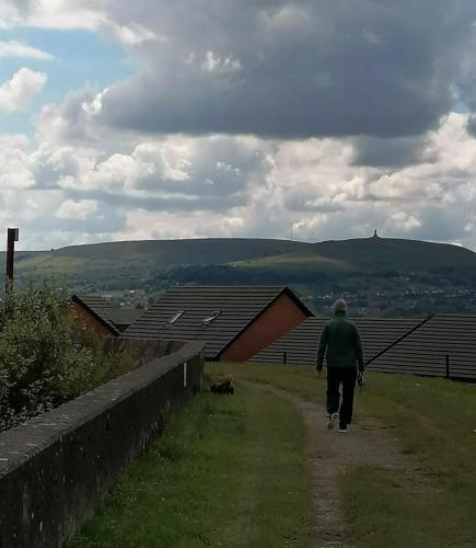 a man is walking down a dirt road at The Nightingale in Lower Darwen