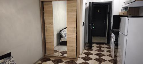 a mirror on a wall in a kitchen next to a refrigerator at Studio 6-2 Hristo Stanechev 2- Dental University in Bŭnzareto