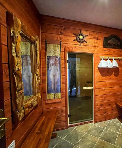 a room with a wooden wall with a glass door at Fort Tenerife Gran Casa de Campo in Tacoronte