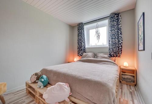 a bedroom with a large bed and a window at Ride by the Sea Guesthouse in Koudekerke