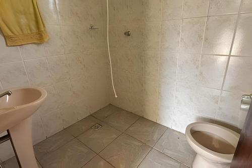 a bathroom with a toilet and a sink at Casa Alpe de Itapeva in Itapeva