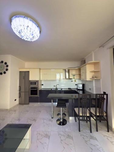a large kitchen with a table and chairs at Sea View Apartaments in Durrës