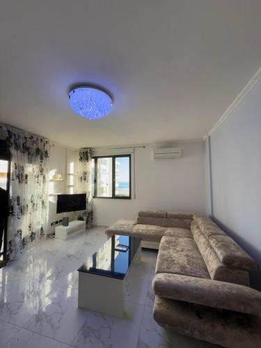 a living room with a couch and a table at Sea View Apartaments in Durrës