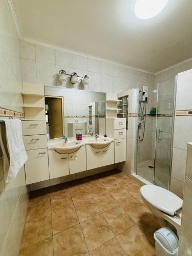 a bathroom with two sinks and a shower at Relaxed Studio Near the Beach in Jan Thiel