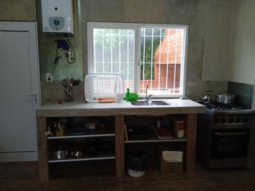 a kitchen with a sink and a window at duplex playa marisol in Balneario Oriente