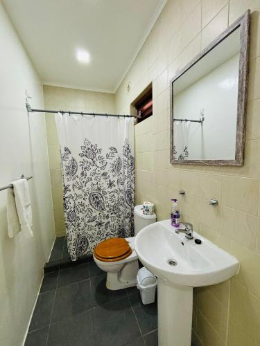a bathroom with a sink and a toilet and a shower at Vibrant Studio Near the Beach in Jan Thiel