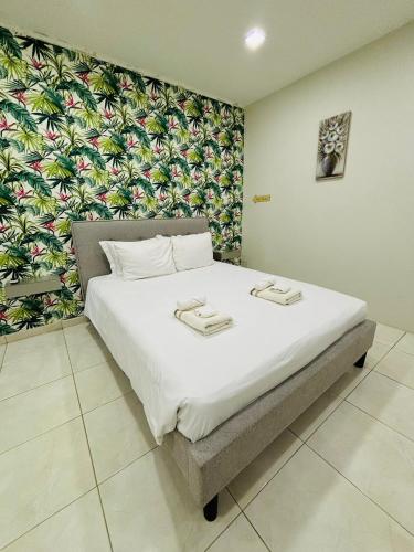 a bedroom with a large white bed with a floral wall at Vibrant Studio Near the Beach in Jan Thiel