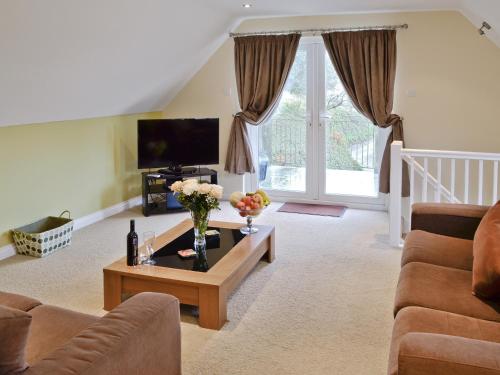 a living room with a couch and a coffee table at Lake View Cottage - Cv7102 in Saint Cleer