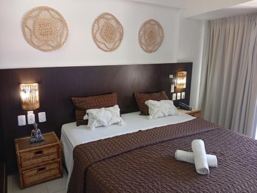 a bedroom with a large bed with white pillows at PIPAS BAY - Aparthotel Vista Mar in Pipa