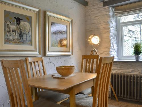 a dining room with a wooden table and chairs at Grange End Coach House in Grasmere