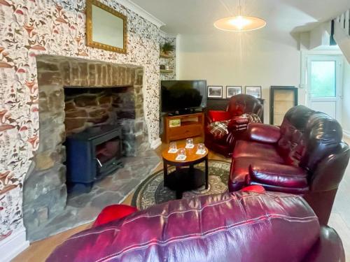 a living room with a couch and a fireplace at Mushroom Cottage in Ferndale