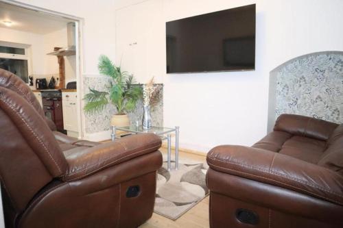 a living room with a couch and a table at The Hidden Gem in Longford