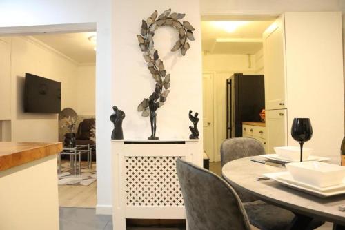 a dining room with a table and a mirror at The Hidden Gem in Longford