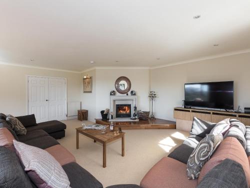 a living room with a couch and a fireplace at North Dean in Winster