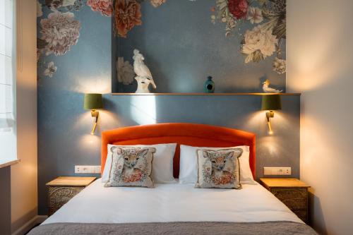 a bedroom with a bed with two pillows at Piotrkowska 89 Residence in Łódź