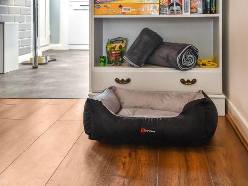 a dog bed sitting on the floor in a living room at Salty Paws in Gorleston-on-Sea
