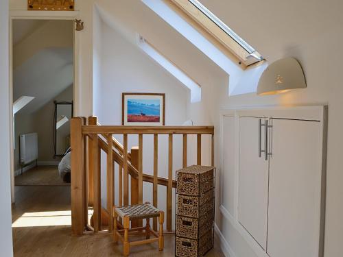 a room with a staircase with a stool and a skylight at Mill Haven in Dunster