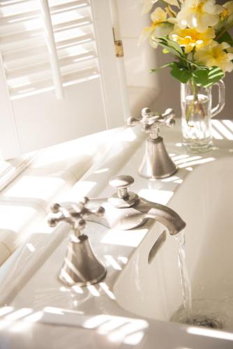 a bathroom sink with water coming out of the faucet at Inn on Putney Road in Brattleboro