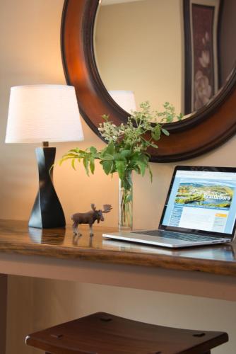 a laptop on a table with a lamp and a plant at Inn on Putney Road in Brattleboro