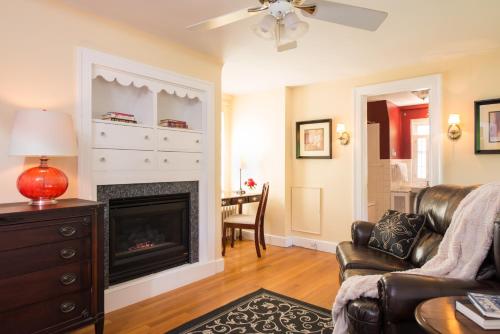 a living room with a fireplace and a couch at Inn on Putney Road in Brattleboro
