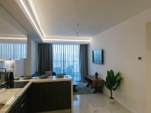 a kitchen and living room with a large window at Grand Sapphire Hotel, Casino & Spa Holiday Deluxe Residential Home in Iskele