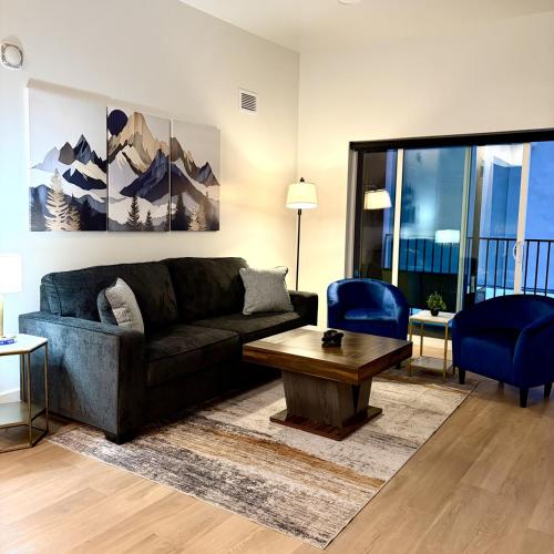 a living room with a couch and a table at Luxury 2 bedroom 2 bath DT Stay in Salt Lake City