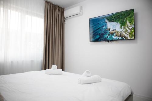 a bedroom with a bed with two towels on it at Garsonieră Studio in Dudu