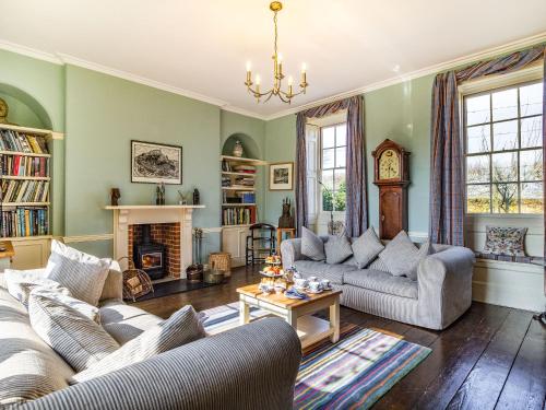 a living room with two couches and a fireplace at Hemblington Hall Arts And Leisure Ltd in South Walsham