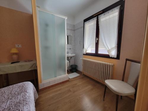 a bedroom with a window and a sink and a mirror at Touring Hotel in Bellegarde-sur-Valserine