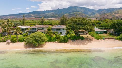 an aerial view of a house on a beach at The Emerald Surf House I home in Waialua