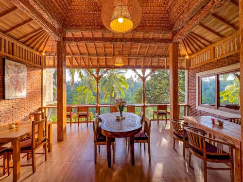 a dining room with a table and chairs at Made Punia's Hidden Jungle Ubud in Ubud
