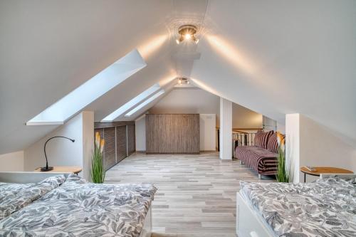 a attic room with two beds and a couch at CitySpace Košická in Nivy