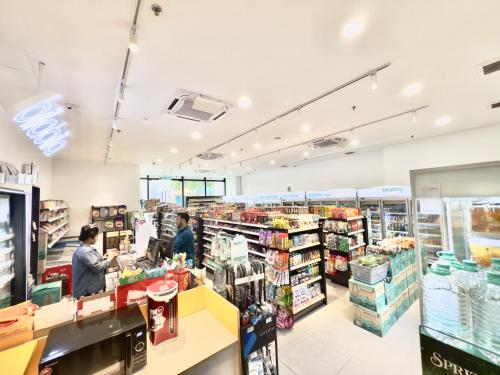 a grocery store with two people in the aisle at Chambers Suites Mrk in Kuala Lumpur